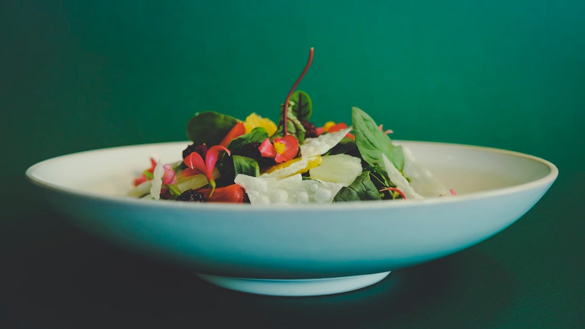 vegetable salad on white ceramic bowl